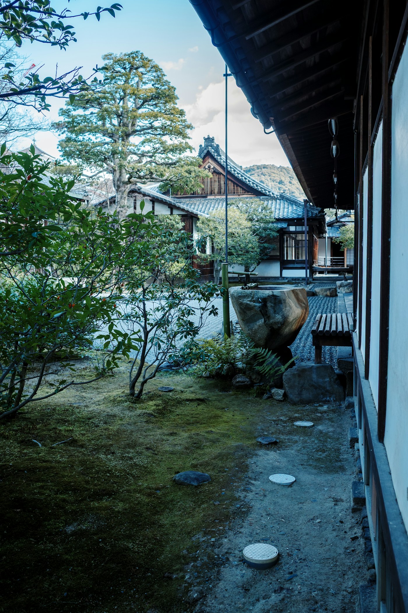 Moss and stones in a traditional Kyoto garden beside wooden architecture