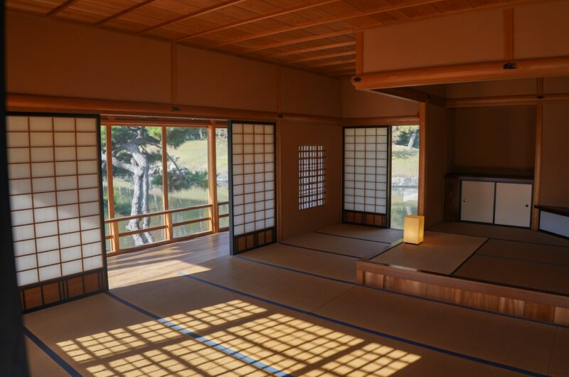 Sunlit traditional Japanese room with shoji screens overlooking a Japanese garden, photographed by Yosuke Ota