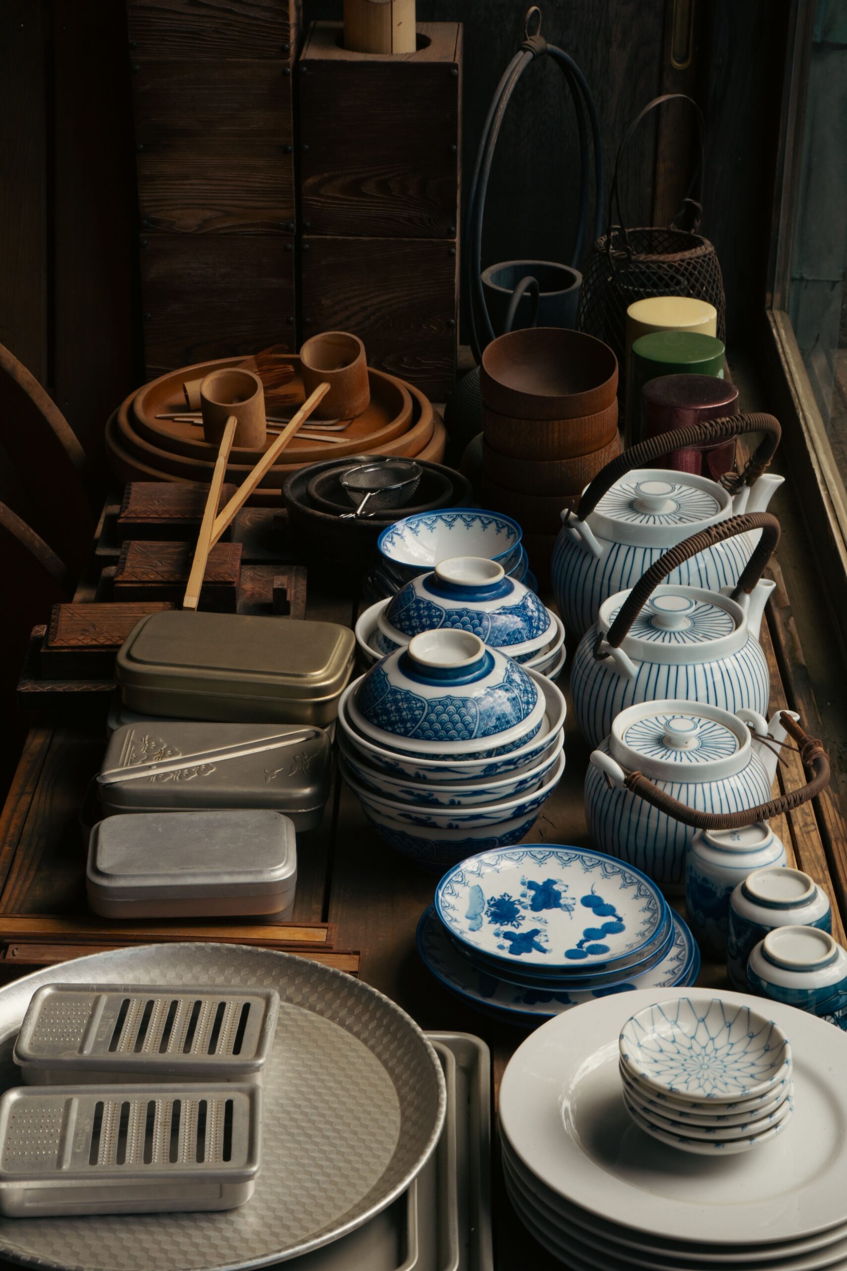 Traditional Japanese pottery and ceramic dishes displayed on a wooden table in Tokyo